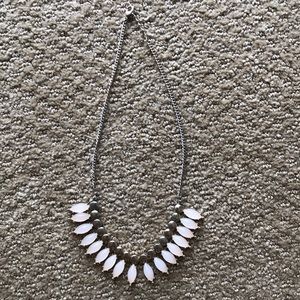 Necklace with light pink stones and gold accent.